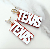 Texas Proud Earrings - White "Texas" over Orange Glitter with White Logo Top